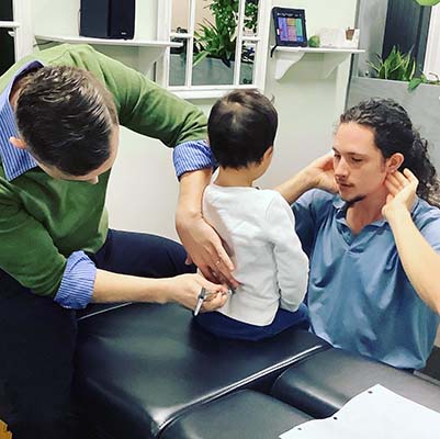 Chiropractor Greensboro NC David Huff Adjusting Child Patient