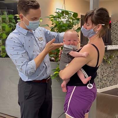 Chiropractor Greensboro NC David Huff With Infant Patient